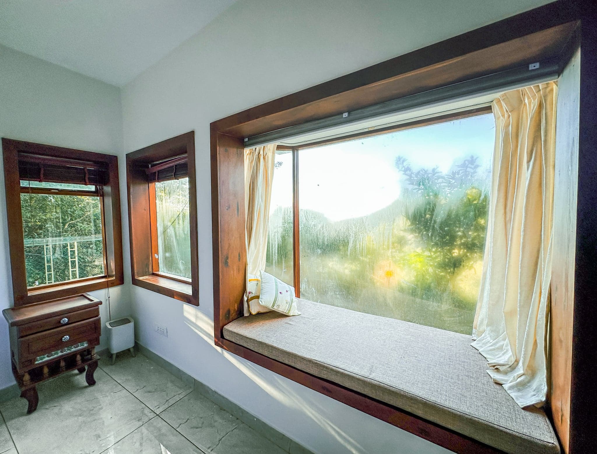 Bedroom window seat looking over the hills at The Sanctuary by Heyday, Panchalimedu, Idukki, Kerala