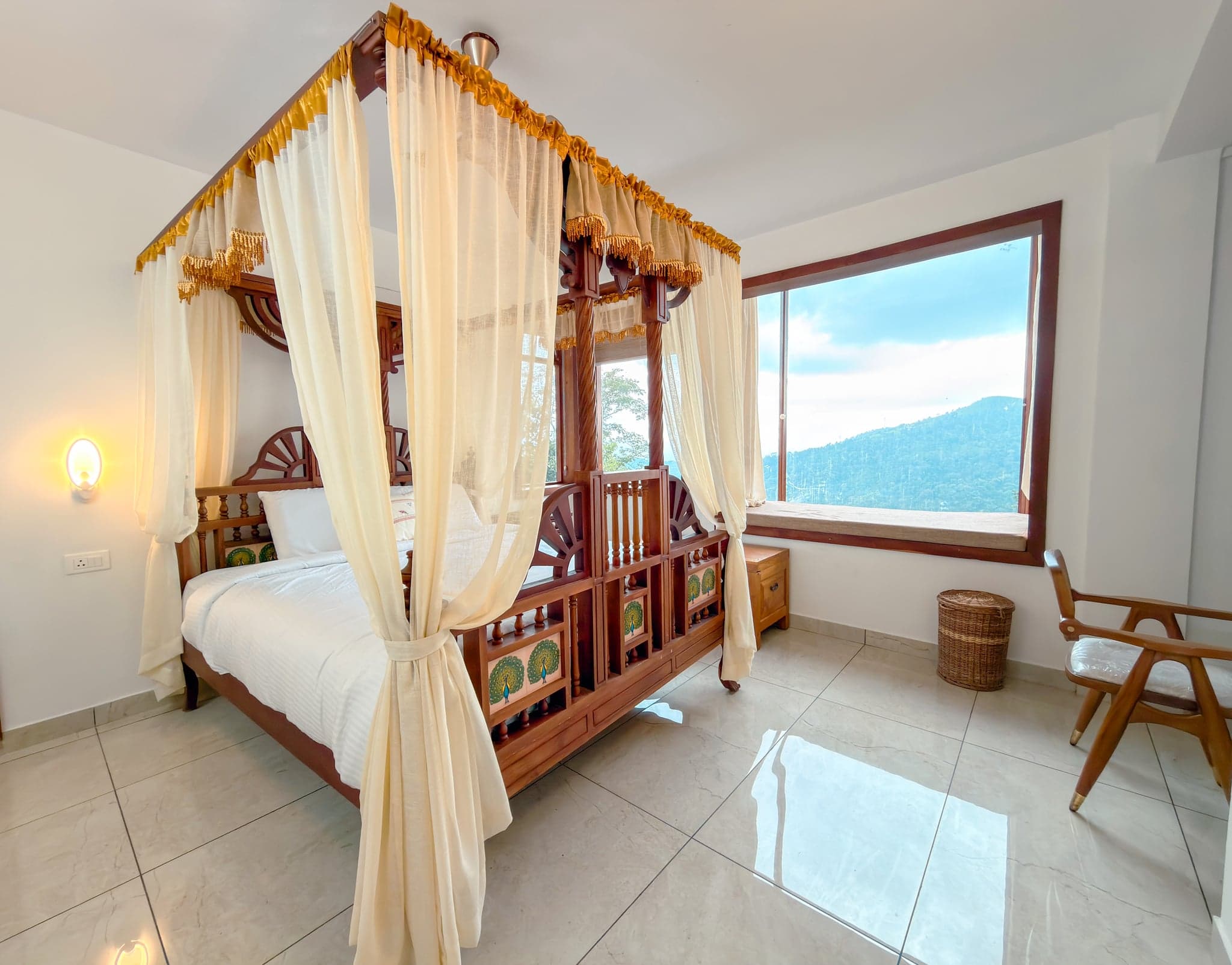 Four-poster bedroom with mountain views at The Sanctuary by Heyday, Panchalimedu, Idukki, Kerala