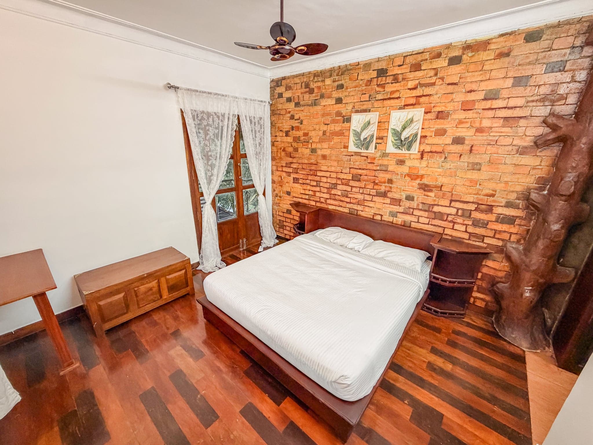 Bedroom with the brick wall at The Sanctuary by Heyday, Panchalimedu, Idukki, Kerala
