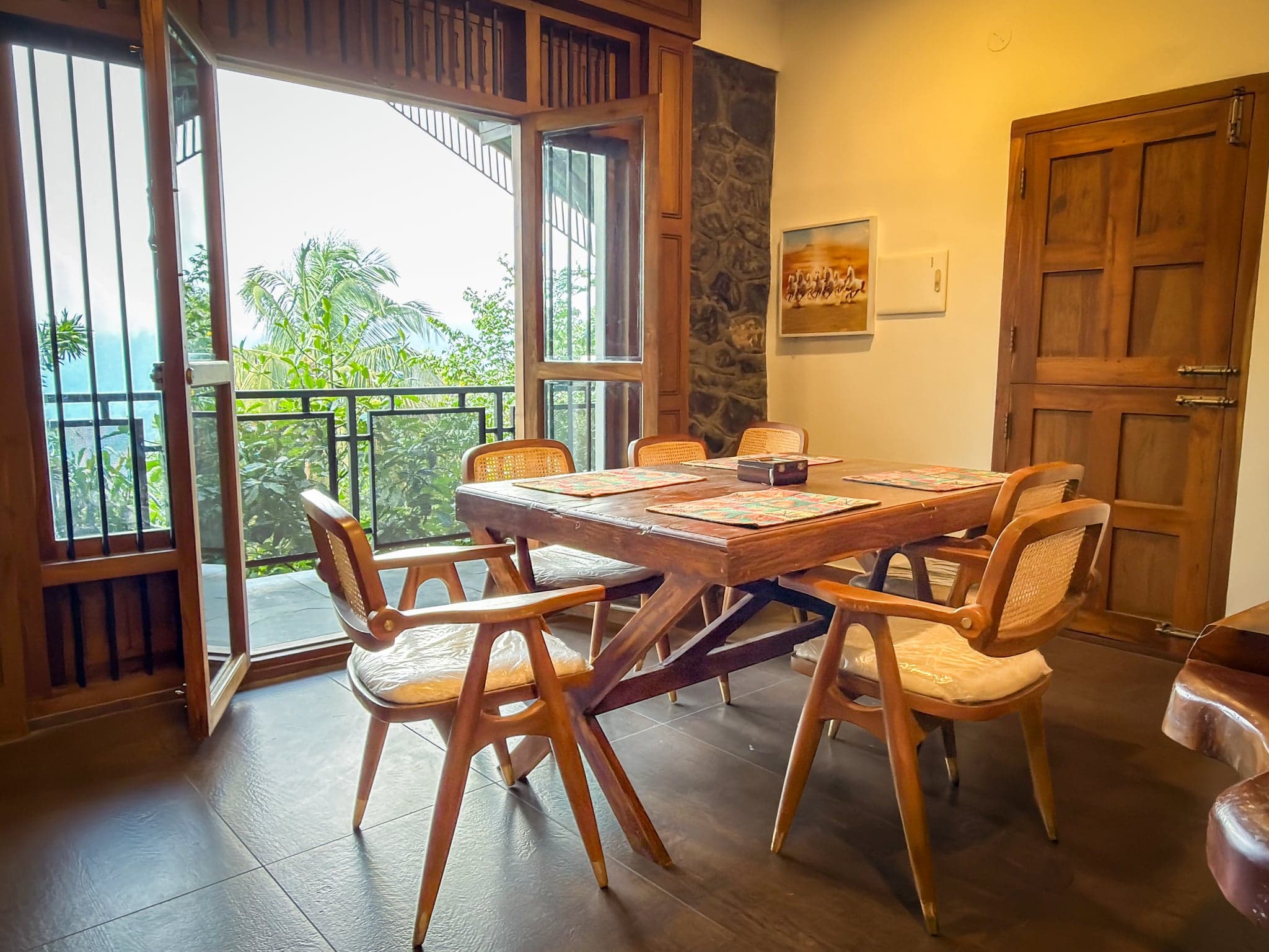 Dining area opening to the balcony at The Sanctuary by Heyday, Panchalimedu, Idukki, Kerala