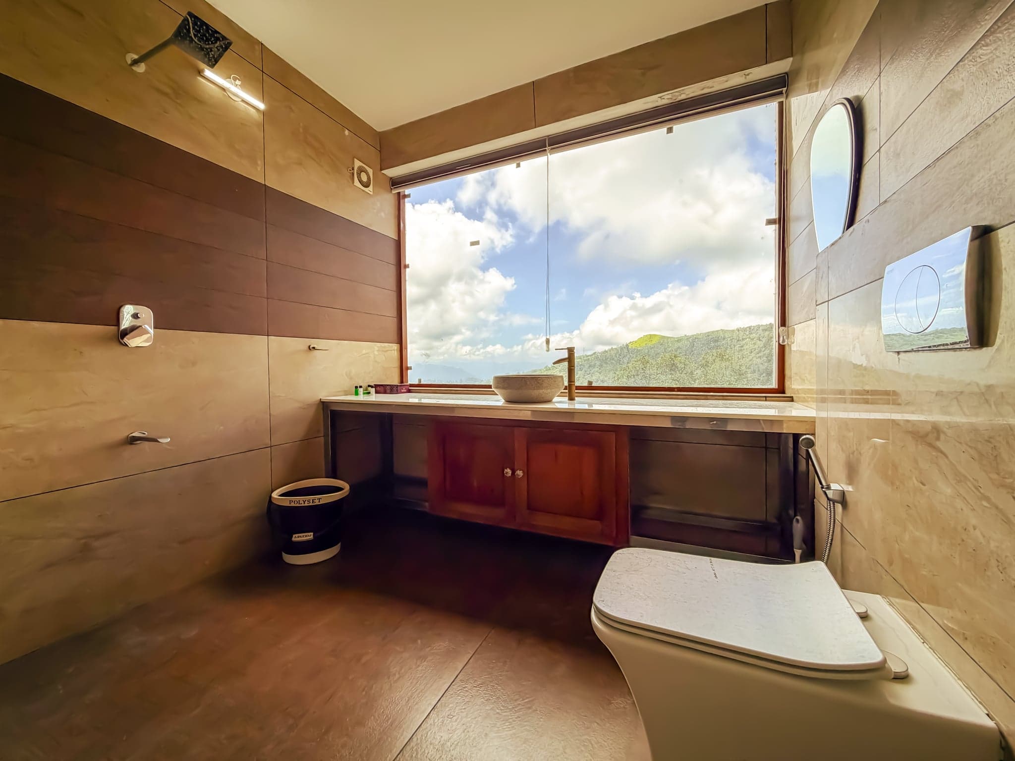 Bathroom with a valley view window at The Sanctuary by Heyday, Panchalimedu, Idukki, Kerala