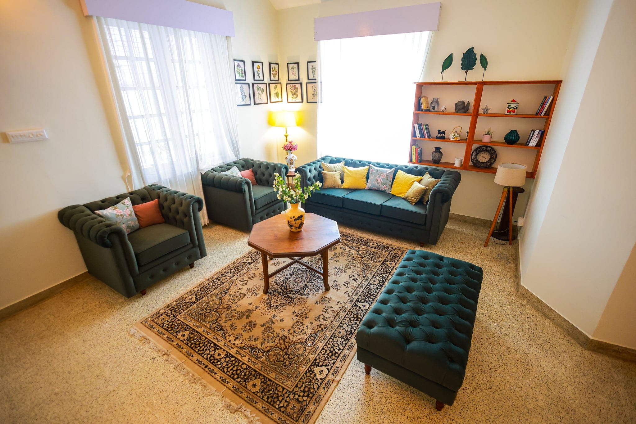 Sitting room with green leather sofas at Heyday Planter's Portico, near Thenmala, Kollam, Kerala