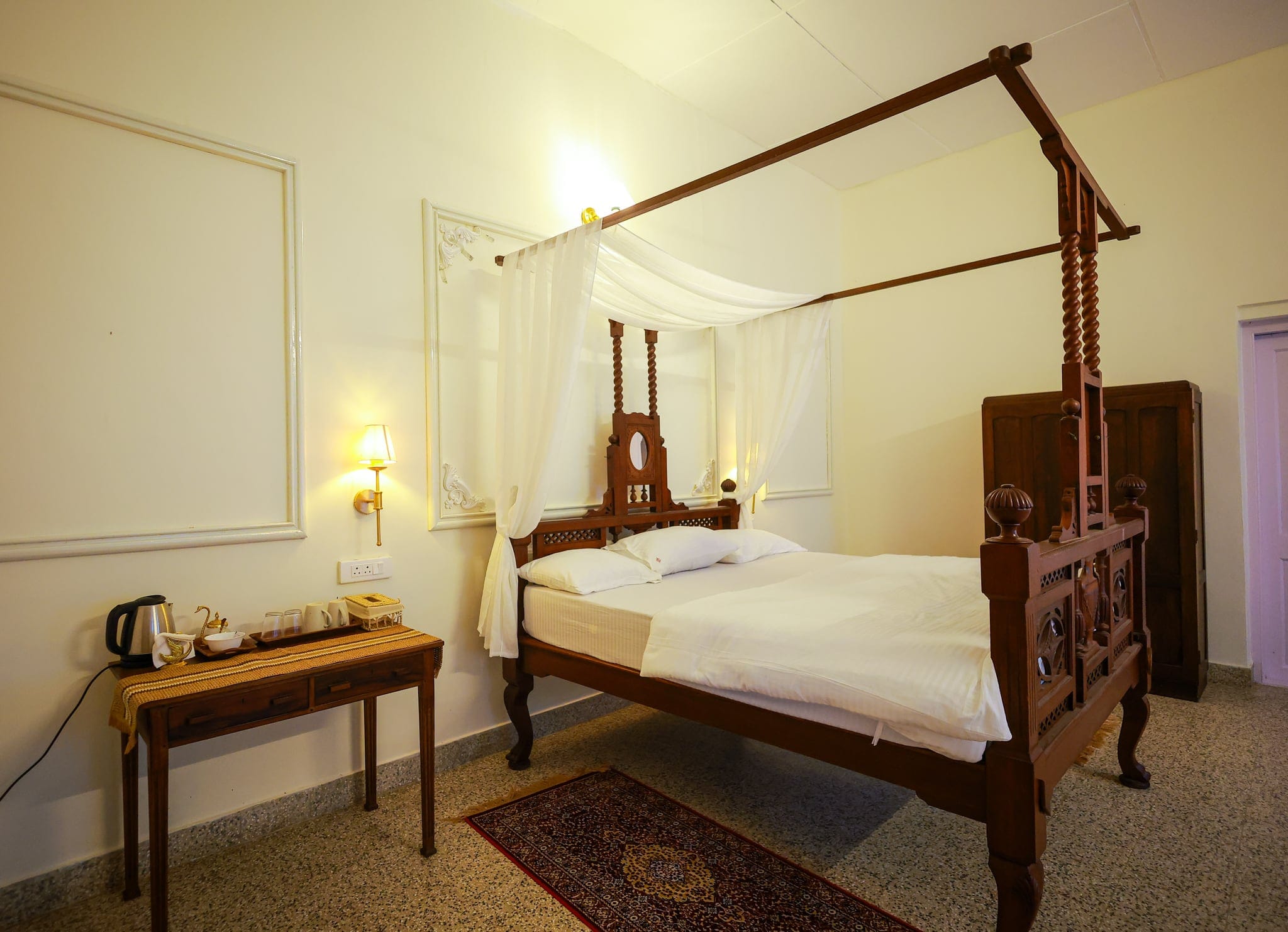 Bedroom with vintage furniture and tall windows at Heyday Planter's Portico, near Thenmala, Kollam, Kerala
